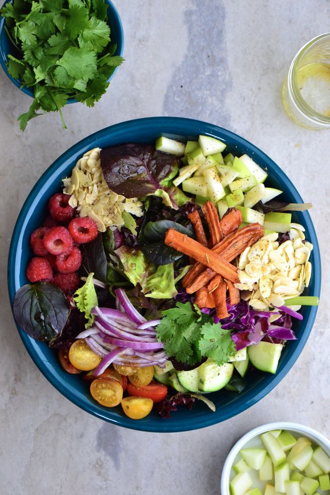 A aerial view of a delicious bowl of colorful fruits and veggies chopped into bite sized pieces.