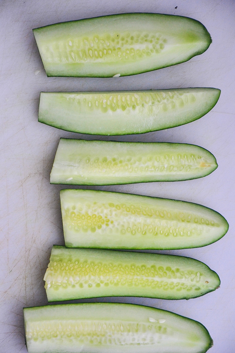 Quartered cucumbers placed in a line.