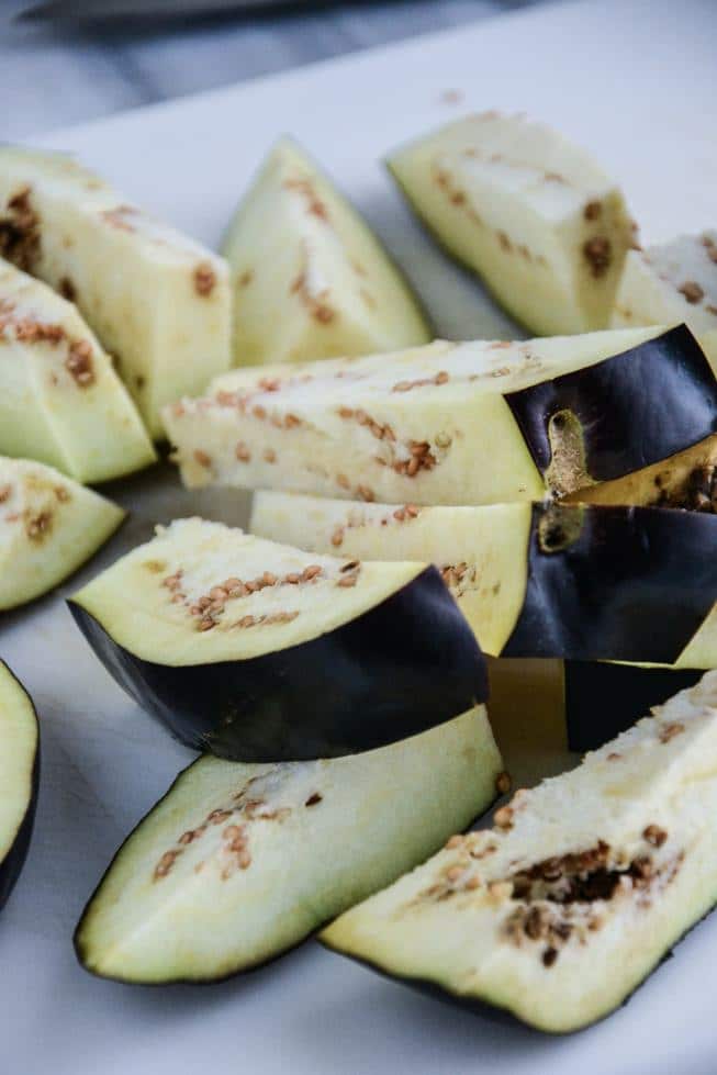 Sliced eggplant fries on a marble table.