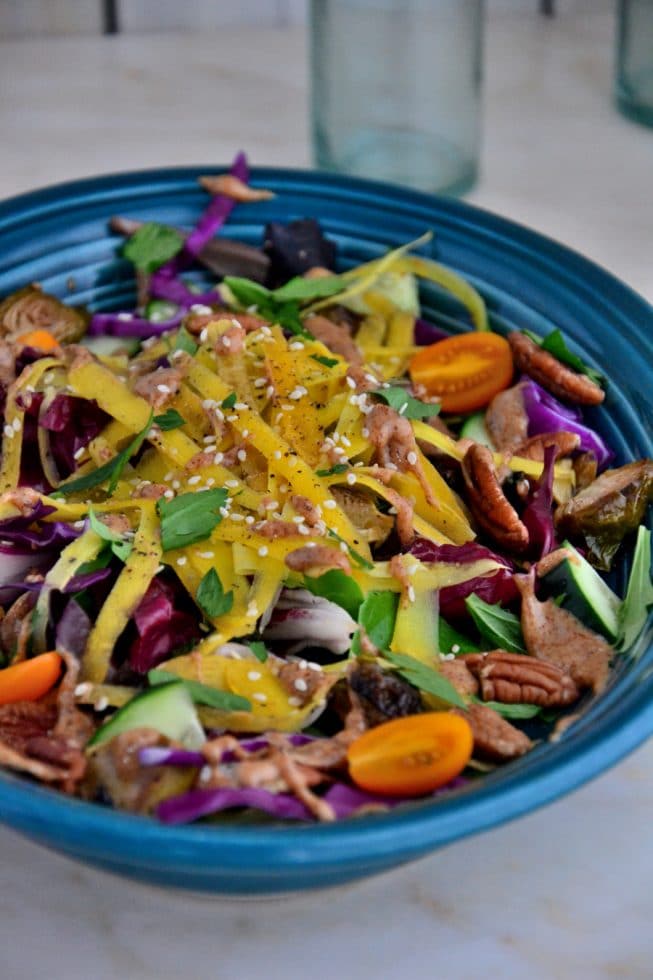 This Brussel Sprout Salad is delicious when served for lunch or dinner. It's full of yellow carrots, salad greens, fresh herbs and more!