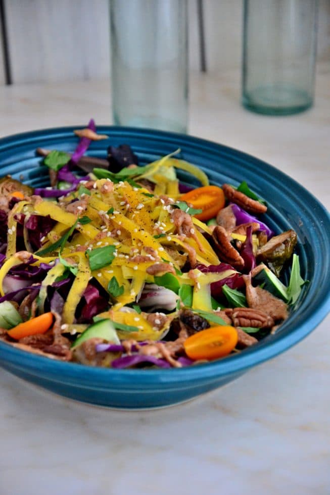 This Brussel Sprout Salad is delicious when served chilled or at room temperature; it's tossed with yellow carrots, cherry tomatoes,cucumbers, salad greens and pecans!