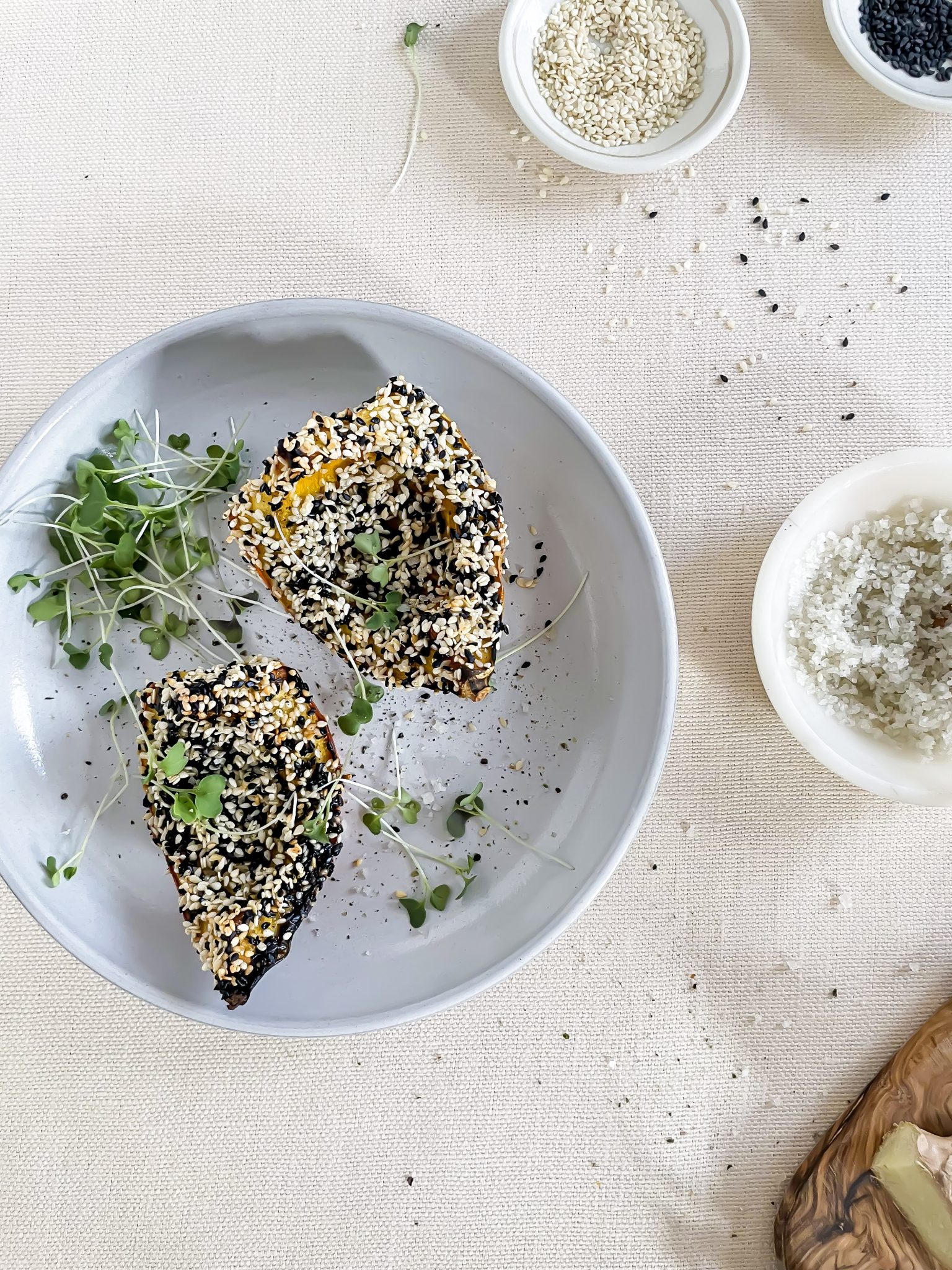 Roasted Garlic + Ginger Squash with Sesame Seed Crust on a white tablecloth with all the ingredients on the table