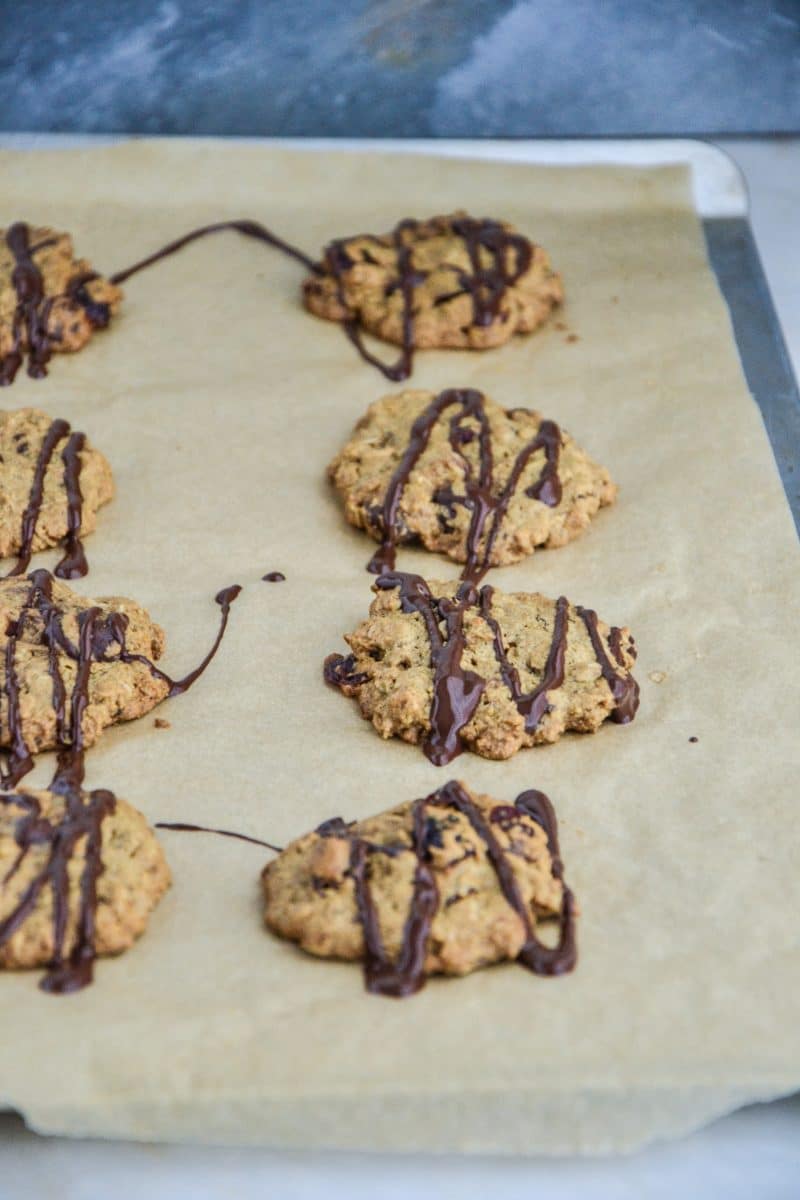 Oatmeal Cranberry Chocolate Chip cookies drizzled on pan