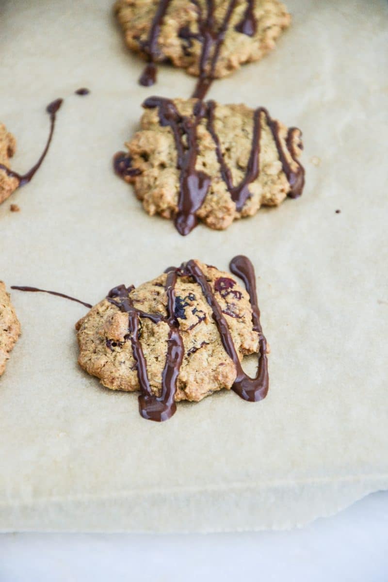 Oatmeal Cranberry Chocolate Chip cookies on parchment paper