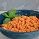 Gluten free rotini pasta coated in a red sauce.