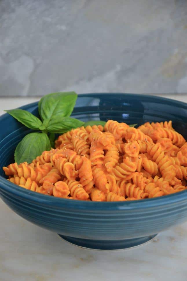 Gluten free rotini pasta coated in red sauce.