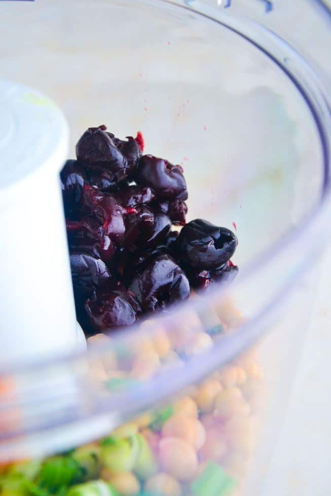 Gluten-Free Falafel being made in a food processor with frozen cherries.