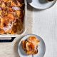 red onion and sweet potato gratin in a staub baking dish on a tan tablecloth