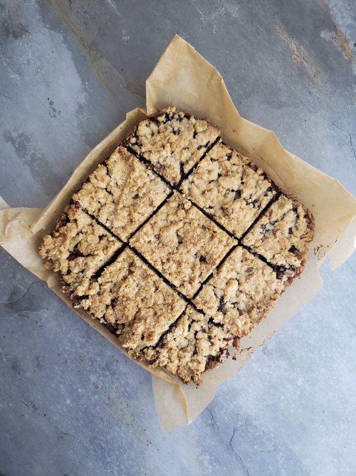 An overhead shot of a baking dish with nine square fresh baked breakfast bars.