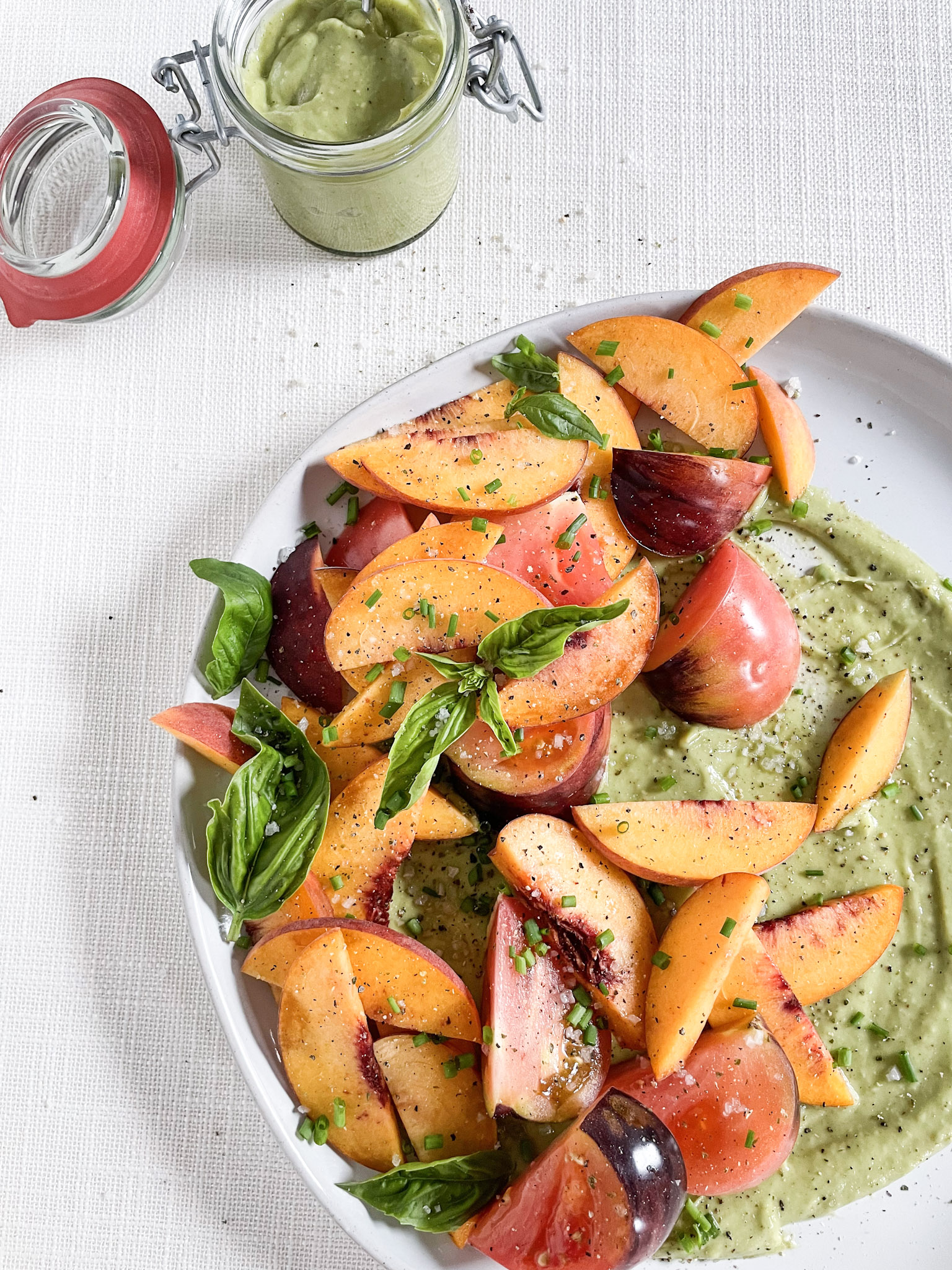 fresh basil and peach salad with heirloom tomato and avocado sauce