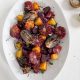 Roasted Beets + Onions with Blood Oranges on a white tablecloth and white oval platter.