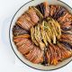 Sweet potato tian recipe on white linen with fresh oregano garnish