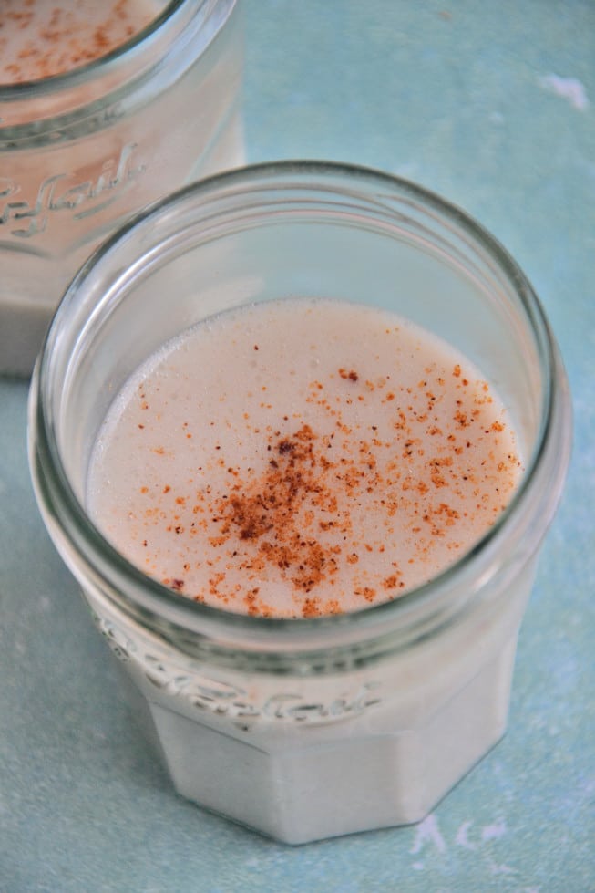A delicious recipe for dairy-free eggnog in a beautiful le parfait glass.