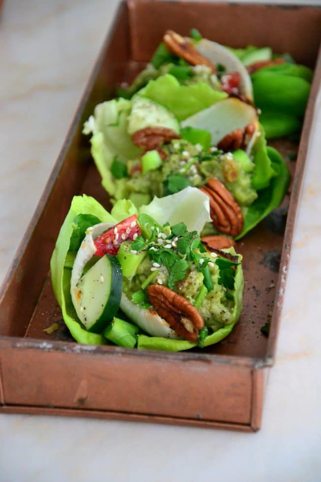 Gorgeous Vegetarian Lettuce Wraps filled with guacamole, fresh veggies, herbs and more on a beautiful platter!