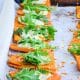 Sweet Potato Appetizer Bites hot out of the oven with arugula on top.