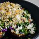 Roasted sweet potato stuffed with quinoa and greens on a skillet.